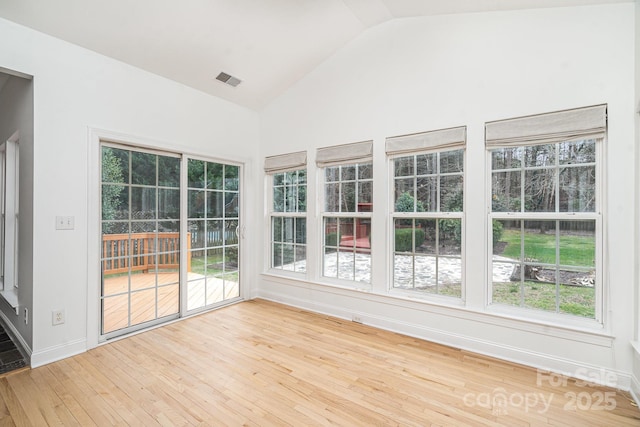 unfurnished sunroom with vaulted ceiling and visible vents