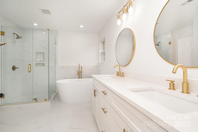 bathroom with marble finish floor, visible vents, and a sink