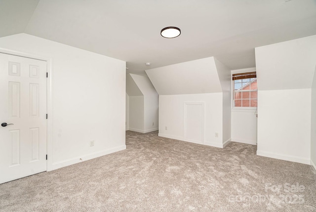 bonus room with vaulted ceiling, carpet, and baseboards