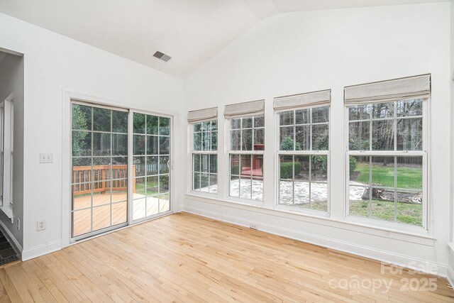 5672 Wrenfield Ct, Charlotte, NC 28277 - unfurnished sunroom with wood-type flooring, healthy amount of natural light, baseboards, and high vaulted ceiling