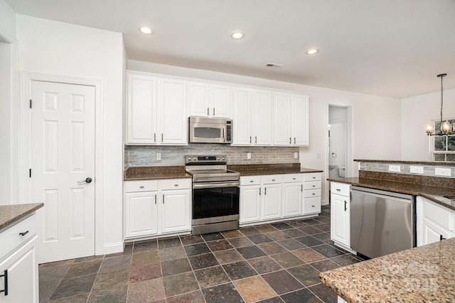 5672 Wrenfield Ct, Charlotte, NC 28277 - kitchen featuring appliances with stainless steel finishes, a chandelier, backsplash, white cabinetry, and recessed lighting