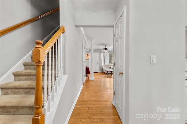 interior space with stairs, light wood-style flooring, and baseboards