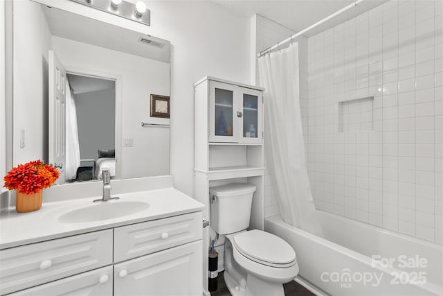 ensuite bathroom featuring vanity, visible vents, shower / bath combination with curtain, ensuite bathroom, and toilet