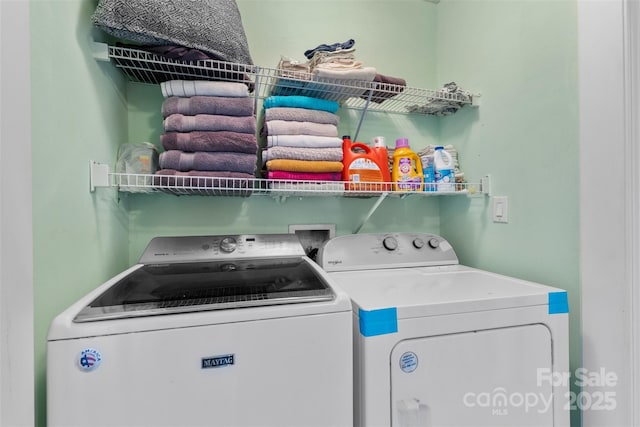 clothes washing area featuring independent washer and dryer and laundry area