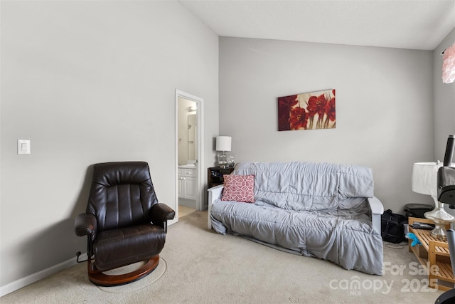 living area featuring baseboards, lofted ceiling, and carpet flooring