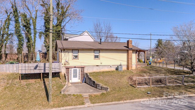 91 Congress St, Asheville, NC 28801 - rear view of house with central AC, fence, a chimney, and a lawn