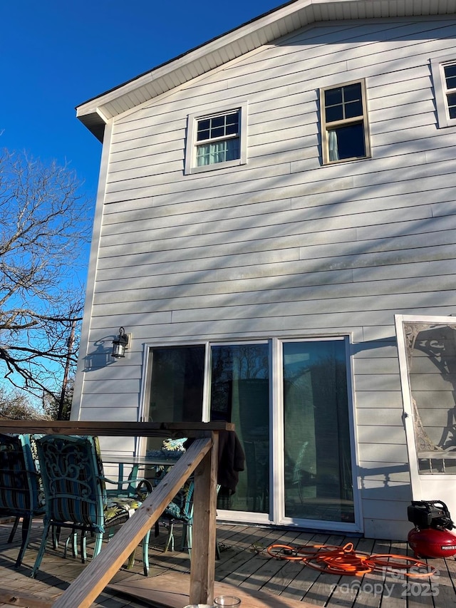 back of property with outdoor dining area