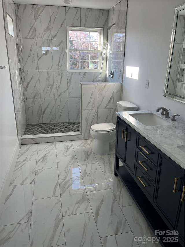 full bathroom with a walk in shower, marble finish floor, and vanity