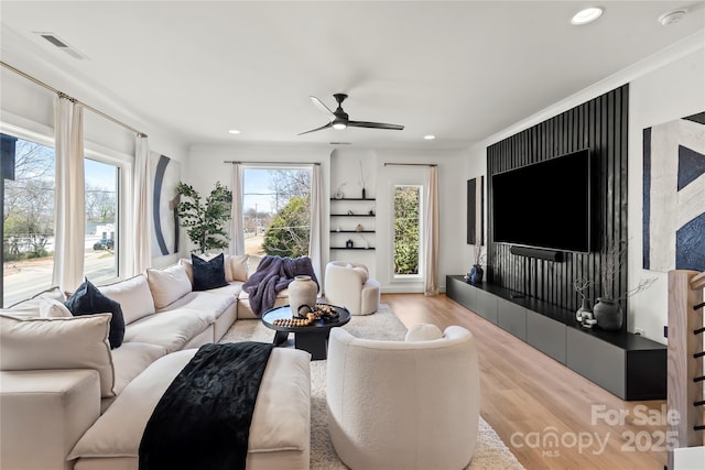 living area featuring a ceiling fan, wood finished floors, visible vents, and recessed lighting