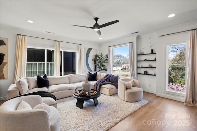 living area with light wood-type flooring, visible vents, a ceiling fan, and recessed lighting