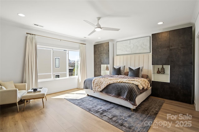 bedroom with light wood finished floors, visible vents, and recessed lighting