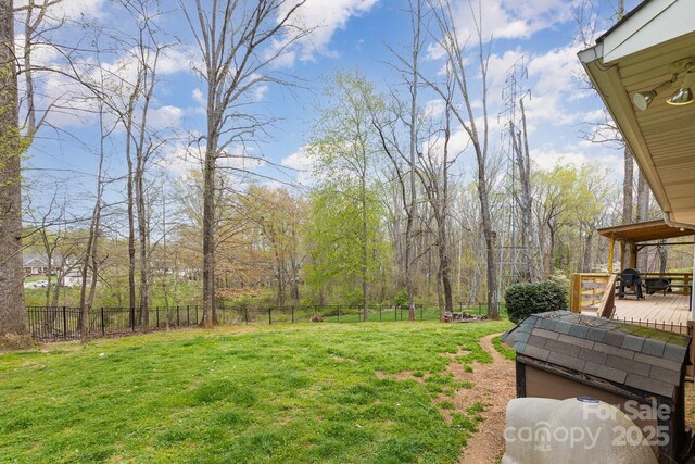 view of yard with fence and a deck