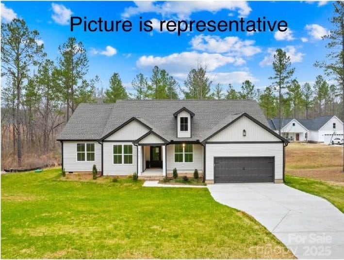 modern inspired farmhouse with driveway, a front lawn, and an attached garage