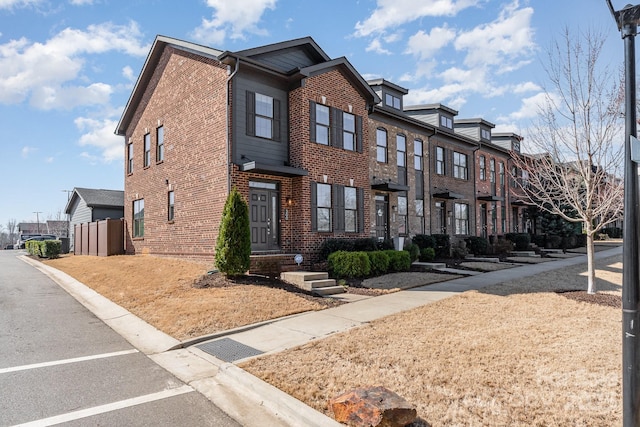 view of front of house with brick siding and a residential view