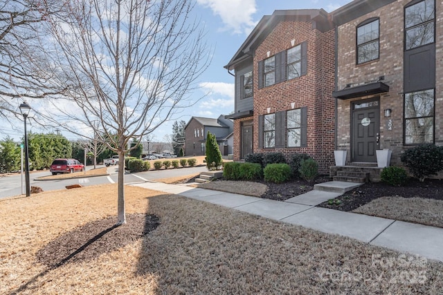 view of property with brick siding