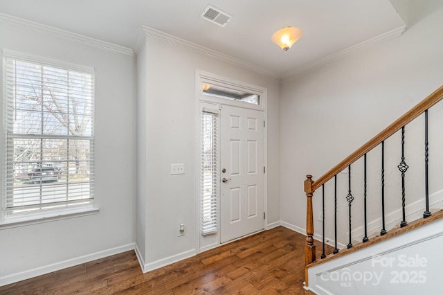 entryway with visible vents, stairway, crown molding, and wood finished floors