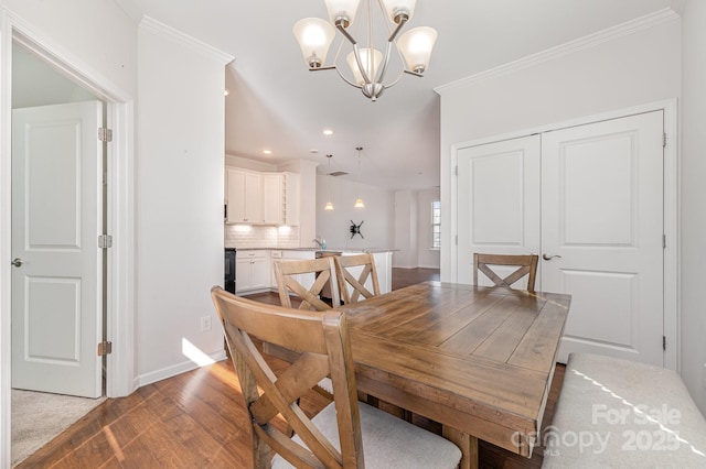 dining room featuring baseboards, light wood-style flooring, recessed lighting, crown molding, and a chandelier