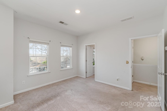 unfurnished room with baseboards, visible vents, and carpet floors