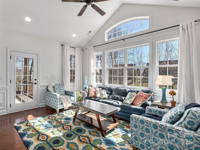 living room with visible vents, lofted ceiling, a wainscoted wall, wood finished floors, and recessed lighting