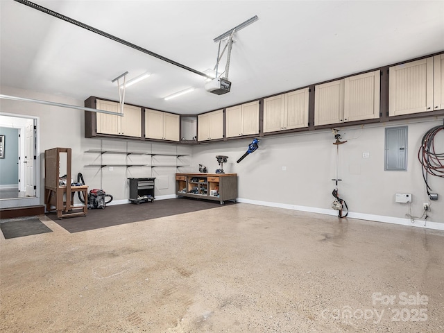 garage with baseboards, electric panel, and a garage door opener