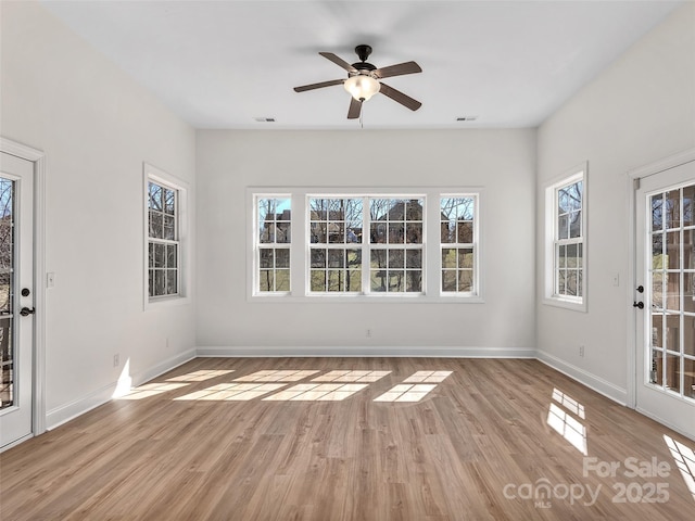 unfurnished sunroom with ceiling fan and visible vents