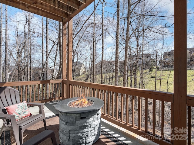 wooden deck featuring a fire pit