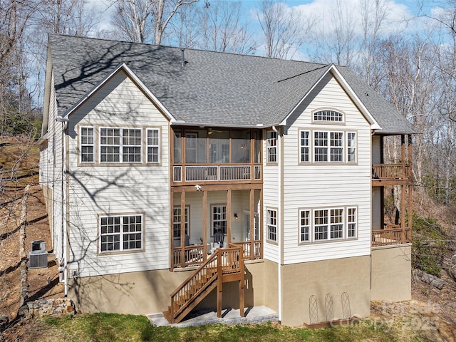 rear view of property with a sunroom, a shingled roof, stairway, and cooling unit