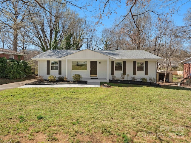 ranch-style home featuring a front yard and a shingled roof