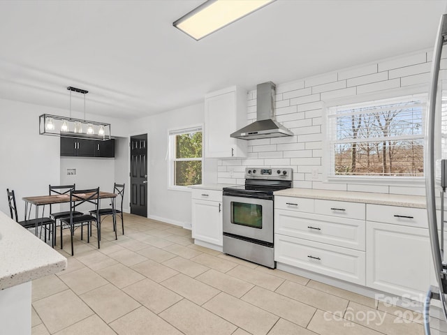 kitchen with electric range, white cabinets, wall chimney range hood, and backsplash