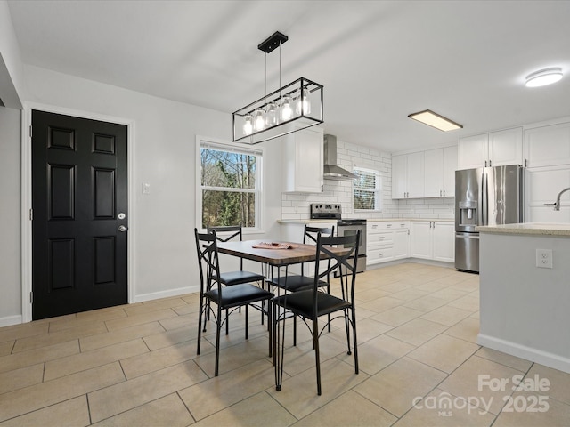 dining area with baseboards and light tile patterned flooring