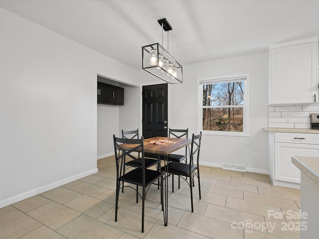 dining area with baseboards, visible vents, and light tile patterned flooring