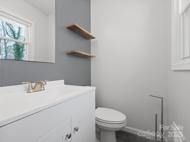 bathroom featuring vanity and toilet