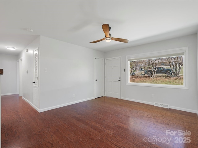 unfurnished room featuring visible vents, ceiling fan, baseboards, and wood finished floors