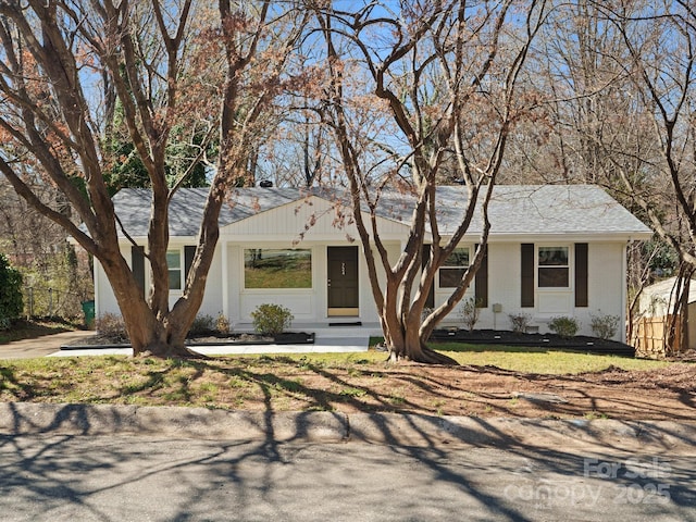 ranch-style house with brick siding and roof with shingles