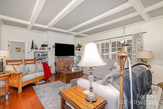 living room with beam ceiling, coffered ceiling, and wood finished floors