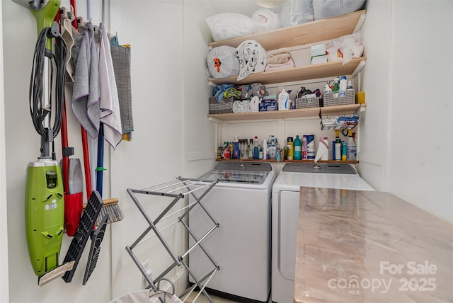 clothes washing area featuring laundry area and washing machine and clothes dryer