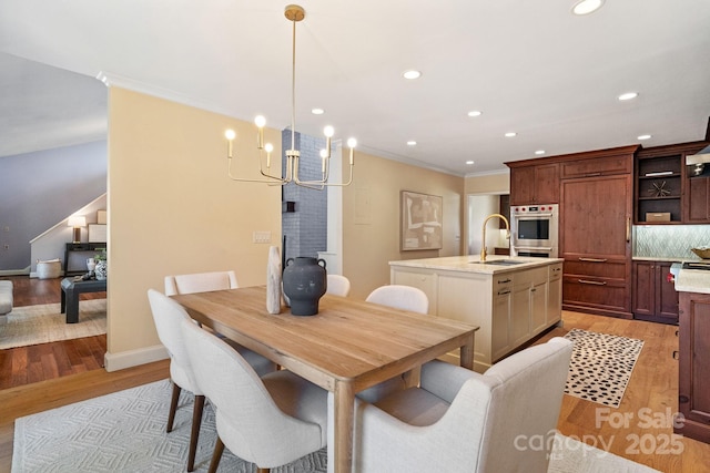 dining room with crown molding, stairway, recessed lighting, and light wood-style floors