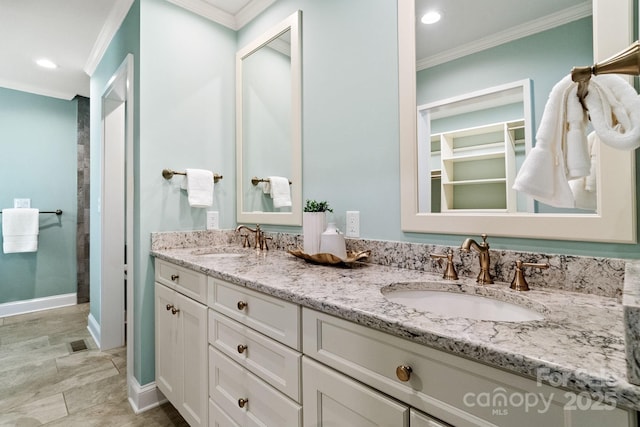 bathroom with crown molding, a sink, baseboards, and double vanity