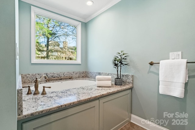 bathroom with a bath, baseboards, and crown molding