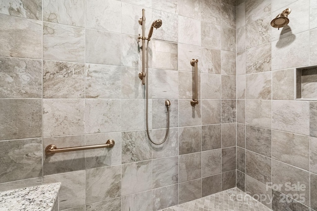 full bath featuring a tile shower