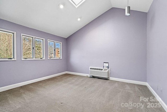 unfurnished room featuring a skylight, baseboards, carpet flooring, a wall mounted AC, and recessed lighting