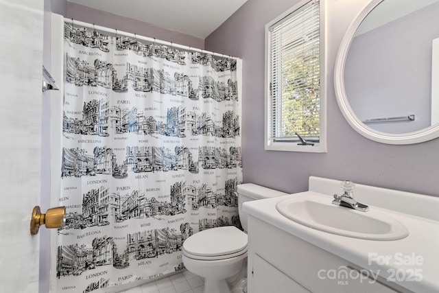 full bath with a shower with shower curtain, vanity, toilet, and tile patterned floors