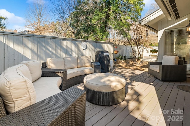 wooden terrace featuring a fenced backyard and an outdoor living space