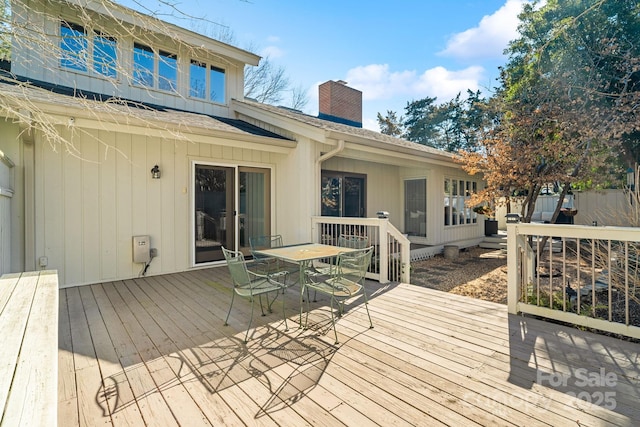 wooden terrace featuring outdoor dining area