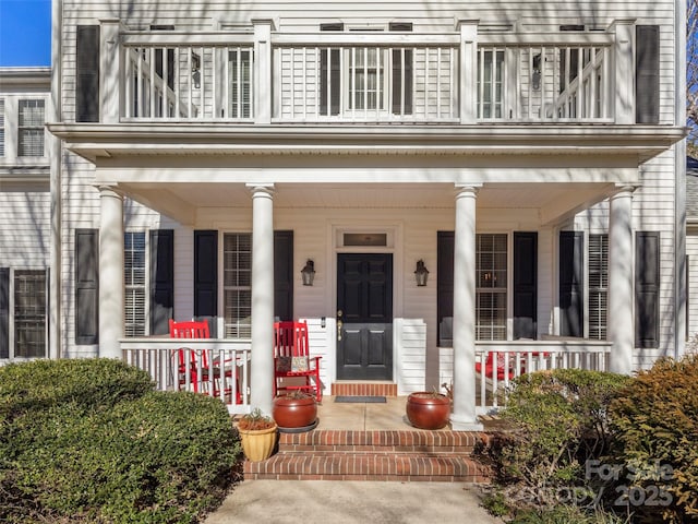 exterior space with a balcony and a porch