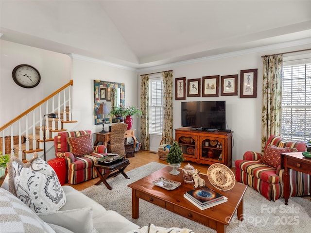 living room featuring a healthy amount of sunlight, stairway, vaulted ceiling, and ornamental molding