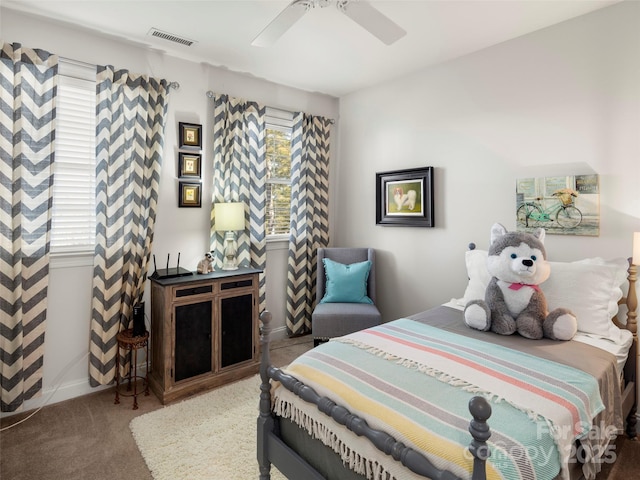 carpeted bedroom with baseboards, visible vents, and a ceiling fan