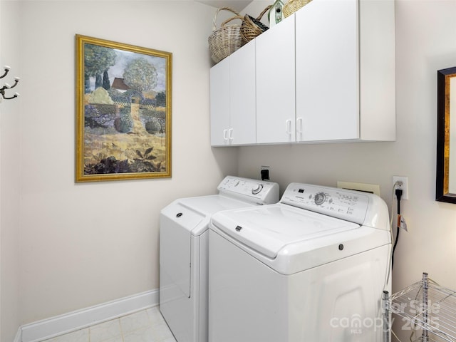 laundry area featuring cabinet space, baseboards, and washer and dryer