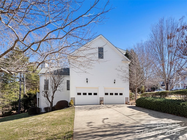 view of home's exterior featuring driveway, a yard, and an attached garage