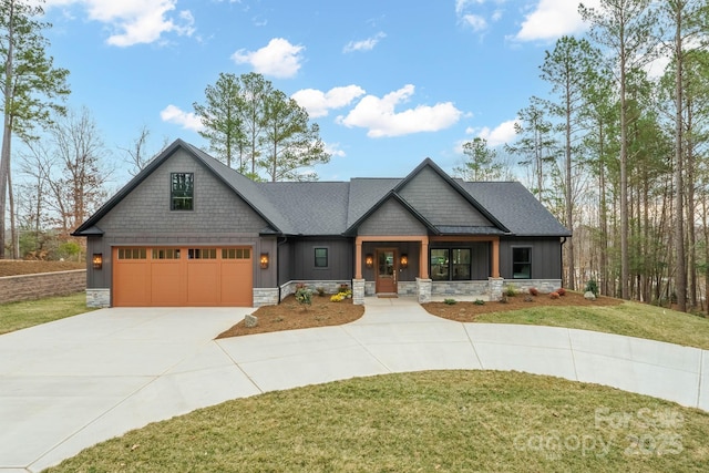 craftsman inspired home featuring stone siding, board and batten siding, and concrete driveway